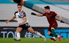Fulham's Antonee Robinson, left, and Wolverhampton Wanderers' Pedro Neto challenge for the ball during the English Premier League soccer match between Fulham and Wolverhampton Wanderers at Craven Cottage stadium in London, England, Friday, April 9, 2021.(Andrew Couldridge/Pool via AP)