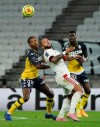 Lyon's Memphis Depay, center, challenges for the ball with Monaco's Florentino Luis, left, and Monaco's Benoit Badiashile during the French League One soccer match between Lyon and Monaco at Groupama stadium in Decines, near Lyon, central France, Sunday, Oct. 25, 2020. (AP Photo/Laurent Cipriani)