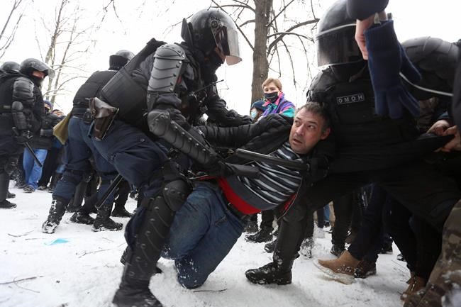 Police detain protesters during a protest against the jailing of opposition leader Alexei Navalny in St. Petersburg, Russia, Sunday, Jan. 31, 2021. Thousands of people have taken to the streets across Russia to demand the release of jailed opposition leader Alexei Navalny, keeping up the wave of nationwide protests that have rattled the Kremlin. Hundreds have been detained by police. (AP Photo/Valentin Egorshin)