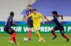 Ukraine's Mykola Matviyenko, center, fights for the ball with France's Kingsley Coman, right, during the World Cup 2022 group D qualifying soccer match between France and Ukraine at the Start de de France stadium, in Saint Denis, north of Paris, Wednesday, March 24, 2021. (AP Photo/Thibault Camus)