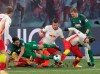 Augsburg's Rani Khedira and Leipzig's goalkeeper Peter Gulacsi battle for the ball during the Bundesliga soccer match between RB Leipzig and FC Augsburg at Red Bull Arena in Leipzig, Germany, Friday, Feb. 12, 2021. (AP Photo/Michael Sohn)