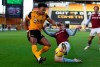 Wolverhampton Wanderers' Adama Traore, left, and Aston Villa's Matt Targett challenge for the ball during the English Premier League soccer match between Wolverhampton and Aston Villa at Molineux Stadium in Wolverhampton, England, Saturday, Dec.12, 2020. (Catherine Ivill/Pool via AP)