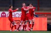 Crawley Town's Jordan Tunnicliffe, right, celebrates after scoring his side's third goal during the English FA Cup third round soccer match between Crawley Town and Leeds United at Broadfield Stadium in Crawley, England, Sunday, Jan. 10, 2021. (AP Photo/Ian Walton)