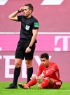 Bayern's Jamal Musiala reacts injured at the ground during the German Bundesliga soccer match between Bayern Munich and FC Union Berlin at Allianz Arena in Munich, Germany, Saturday, April 10, 2021.(Sven Hoppe/Pool via AP)