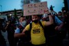 Police remove a Barcelona soccer fan from the Camp Nou stadium during a protest against the club's president Josep Maria Bartomeu, in Barcelona, Spain, Wednesday, Aug. 26, 2020. Lionel Messi has told Barcelona he wants to leave the club after nearly two decades with the Spanish giant. (AP Photo/Felipe Dana)