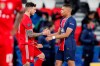 PSG's Kylian Mbappe, right, greets Bayern's Lucas Hernandez at the end of the Champions League, second leg, quarterfinal soccer match between Paris Saint Germain and Bayern Munich at the Parc des Princes stadium, in Paris, France, Tuesday, April 13, 2021. (AP Photo/Francois Mori)