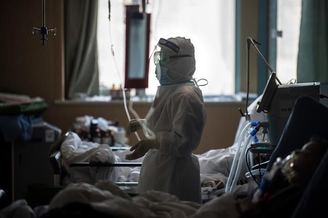 In this Saturday, Feb. 22, 2020, photo released by Xinhua News Agency, a nurse works at an ICU ward specialised for patients infected by coronavirus in Wuhan in central China's Hubei Province. Warning that China's virus epidemic is