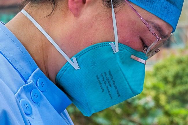 In this Saturday, Feb. 22, 2020, photo released by Xinhua News Agency, a doctor sheds tears after a video call with her son at a hospital in Wuhan in central China's Hubei Province. Warning that China's virus epidemic is