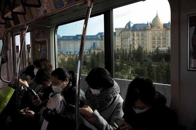 The Tokyo Disney Resort is seen from a train in Urayasu, near Tokyo, Friday, Feb. 28, 2020. The amusement park will be closed from Feb. 29 until March 15 in an effort to prevent the spread of COVID-19. (AP Photo/Jae C. Hong)