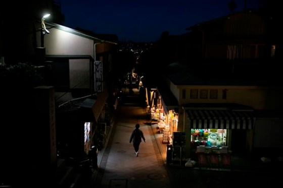 Jae C. Hong / The Associated PressA woman walks down a narrow road lined with restaurants and shops on Enoshima Island in Fujisawa, Japan, Thursday, Feb. 27, 2020. According to local businesses in the area, the number of visitors has dropped significantly since the outbreak of COVID-19. (AP Photo/Jae C. Hong)