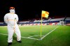 A Conmebol worker stands guard on the pitch at the 