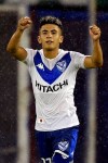 Thiago Almada, top, of Argentina's Velez Sarsfield celebrates after scoring against Colombia's Deportivo Cali during a Copa Sudamericana soccer match at Jose Amalfitani stadium in Buenos Aires, Argentina, Tuesday, Nov. 24, 2020. (Juan Mabromata/Pool via AP )