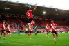 Southampton's Che Adams celebrates after scoring his side's opening goal during the English Premier League soccer match between Southampton and Sheffield United, at St. Mary's stadium in Southampton, England, Saturday, Dec. 13, 2020. (Naomi Baker/Pool via AP)