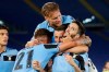 Lazio's Luis Alberto, right, celebrates with his teammates Sergej Milinkovic-Savic,Adam Marusic and Ciro Immobile, on top, after scoring his side's second goal during a Serie A soccer match between Lazio and Fiorentina at Rome's Olympic stadium, Saturday, June 27, 2020. (AP Photo/Riccardo de Luca)