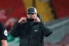 Liverpool's manager Jurgen Klopp fixes his protective mask during the English Premier League soccer match between Liverpool and Brighton at Anfield stadium, in Liverpool, England, Wednesday, Feb. 3, 2021.(Clive Brunskill/Pool via AP)