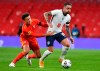 England's Danny Ings, right, dribbles past Wales' Ethan Ampadu, during the international friendly soccer match between England and Wales at Wembley stadium in London, Thursday Oct. 8, 2020. (Glynn Kirk/Pool via AP)