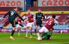 Leeds United's Patrick Bamford, left, shoots to score during the English Premier League soccer match between Aston Villa and Leeds United at Villa Park in Birmingham, England, Friday, Oct. 23, 2020. (Laurence Griffiths/Pool via AP)