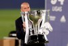 Real Madrid's head coach Zinedine Zidane, holds the trophy as he poses for the photographers after winning the Spanish La Liga 2019-2020 following a soccer match between Real Madrid and Villareal at the Alfredo di Stefano stadium in Madrid, Spain, Thursday, July 16, 2020. (AP Photo/Bernat Armangue)