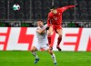 Bayern's Robert Lewandowski, right, heads the ball in front of Moenchengladbach's Stefan Lainer, left, during the German Bundesliga soccer match between Borussia Moenchengladbach and Bayern Munich at the Borussia Park in Moenchengladbach, Germany, Friday, Jan. 8, 2021. (AP Photo/Martin Meissner, Pool)