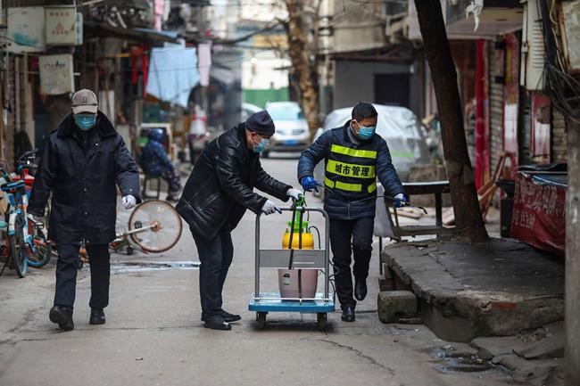 Chinatopix / The Associated Press Files
Government workers spray disinfectant along a street in Wuhan in central China's Hubei Province, Tuesday, Jan. 28, 2020. Hong Kong's leader announced Tuesday that all rail links to mainland China will be cut starting Friday as fears grow about the spread of a new virus. (Chinatopix via AP)