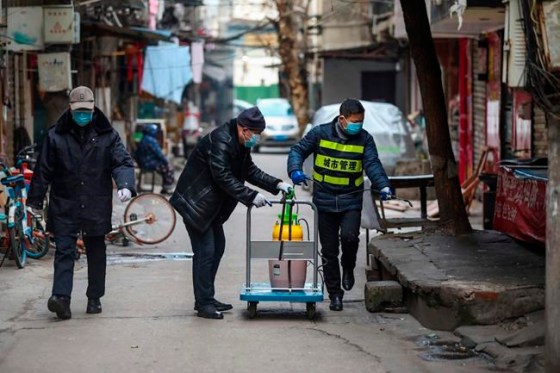 Chinatopix / The Associated Press FilesGovernment workers spray disinfectant along a street in Wuhan in central China's Hubei Province, Tuesday, Jan. 28, 2020. Hong Kong's leader announced Tuesday that all rail links to mainland China will be cut starting Friday as fears grow about the spread of a new virus. (Chinatopix via AP)