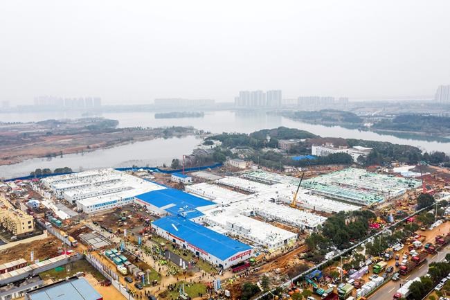 The Huoshenshan temporary field hospital under construction is seen as it nears completion in Wuhan in central China's Hubei Province, Sunday, Feb. 2, 2020. The Philippines on Sunday reported the first death from a new virus outside of China, where authorities delayed the opening of schools in the worst-hit province and tightened quarantine measures in a city that allow only one family member to venture out to buy supplies. (Chinatopix via AP)