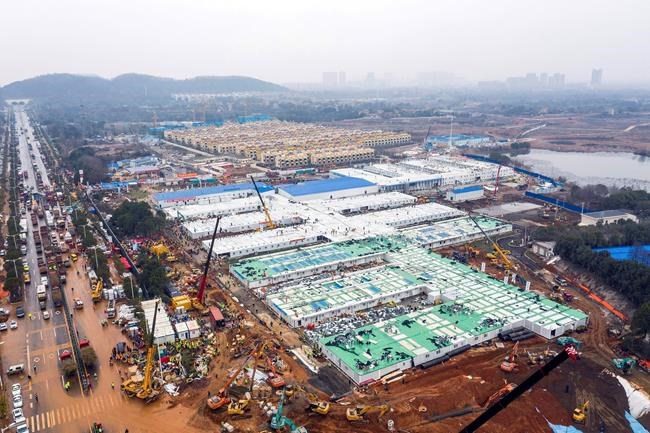 The Huoshenshan temporary field hospital under construction is seen as it nears completion in Wuhan in central China's Hubei Province, Sunday, Feb. 2, 2020. The Philippines on Sunday reported the first death from a new virus outside of China, where authorities delayed the opening of schools in the worst-hit province and tightened quarantine measures in a city that allow only one family member to venture out to buy supplies. (Chinatopix via AP)