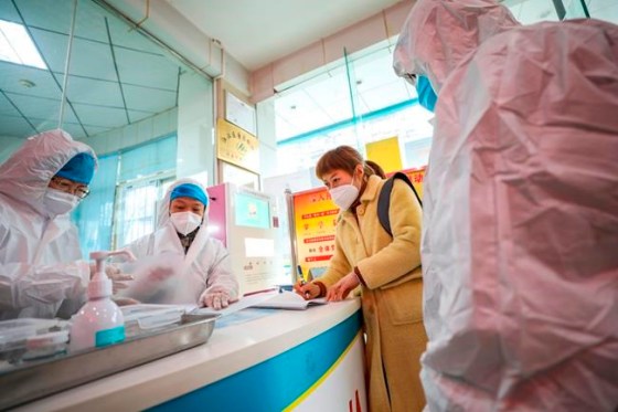 Chinatopix / The Associated PressMedical workers in protective gear talk with a woman suspected of being ill with a coronavirus at a community health station in Wuhan in central China's Hubei Province, Monday, Jan. 27, 2020. China on Monday expanded sweeping efforts to contain a viral disease by extending the Lunar New Year holiday to keep the public at home and avoid spreading infection. (Chinatopix via AP)