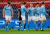 Manchester City's Kevin De Bruyne, third right, is congratulated by teammates after scoring his team's first goal during the Champions League round of 16 second leg soccer match between Manchester City and Borussia Moenchengladbach at the Puskas Arena in Budapest, Hungary, Tuesday, March 16, 2021. (AP Photo/Laszlo Balogh)