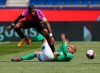 PSG's Presnel Kimpembe, left, leaps above Saint-Etienne's Wahbi Khazri as they compete for the ball during the French League One soccer match between Paris Saint-Germain and St Etienne at Parc Des Princes in Paris, France, Sunday, April 18, 2021. (AP Photo/Francois Mori)
