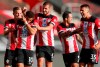 Southampton's Che Adams, second left, is congratulated by teammates after scoring his team's first goal during the English Premier League soccer match between Southampton and Manchester City at St. Mary's Stadium in Southampton, England, Sunday, July 5, 2020. (AP Photo/Frank Augstein,Pool)