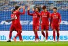 Liverpool's Mohamed Salah, centre, is congratulated by teammates after scoring his team's first goal during the English Premier League soccer match between Brighton and Liverpool at Falmer Stadium in Brighton, England, Wednesday, July 8, 2020. (AP Photo/Catherine Ivill,Pool)