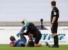 Crystal Palace's Mamadou Sakho receives treatment during the English Premier League soccer match between Wolverhampton Wanderers and Crystal Palace at Molineux Stadium in Wolverhampton, England, Monday, July 20, 2020. (AP Photo/Martin Rickett,Pool)