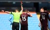 Referee Andre Marriner, left, shows a red card to Leeds United's Liam Cooper, second right, during the English Premier League soccer match between Manchester City and Leeds United at Etihad Stadium, Manchester, England, Saturday April 10, 2021. (AP Photo/Michael Regan,Pool)