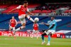 Arsenal's Pierre-Emerick Aubameyang, left, is airborne as he kicks at the ball away from Manchester City's Benjamin Mendy during the FA Cup semifinal soccer match between Arsenal and Manchester City at Wembley in London, England, Saturday, July 18, 2020. (AP Photo/Matt Childs,Pool)