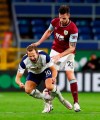 Tottenham's Harry Kane reacts as he is tackled by Burnley's Kevin Long, right, during the English Premier League soccer match between Burnley and Tottenham Hotspur at Turf Moor stadium Burnley, England, Monday, Oct. 26, 2020. (Jason Cairnduff/Pool via AP)