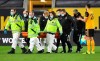 Medical staff carry Wolverhampton Wanderers' goalkeeper Rui Patricio from the pitch during the English Premier League soccer match between Wolverhampton Wanderers and Liverpool at Molineux Stadium in Wolverhampton, England, Monday, March. 15, 2021. (AP Photo/Paul Ellis,Pool)