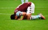 Aston Villa's Trezeguet kisses the pitch after the English Premier League soccer match between Aston Villa and Arsenal at Villa Park in Birmingham, England, Tuesday, July 21, 2020. (AP Photo/Rui Vieira,Pool)
