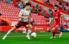 Arsenal's Kieran Tierney, left, looks t take the ball past Liverpool's Mohamed Salah during the English Premier League soccer match between Liverpool and Arsenal at Anfield in Liverpool, England, Monday, Sept. 28, 2020. (Paul Ellis/Pool via AP)