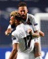 PSG's Neymar celebrates with teammate Eric Maxim Choupo-Moting after his team's win in the Champions League quarterfinal match between Atalanta and PSG at Luz stadium, Lisbon, Portugal, Wednesday, Aug. 12, 2020. (David Ramos/Pool Photo via AP)