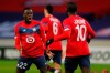 Lille's Timothy Weah, left and Lille's Jonathan Ikone celebrate after their teammate Lille's Burak Yilmaz scored his side's first goal during their Europa League Group H soccer match between Lille and AC Sparta Praha at the Stade Pierre Mauroy stadium in Villeneuve d'Ascq, northern France, Thursday, Dec. 3, 2020. (AP Photo/Michel Spingler)