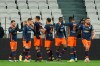 Montpellier's team players celebrate after Teji Savanier, left, scored their side's first goal during the French League One soccer match between Lyon and Montpellier in Decines, near Lyon, central France, Saturday, Feb. 13, 2021. (AP Photo/Laurent Cipriani)