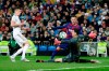 Real Madrid's goalkeeper Thibaut Courtois, right, tries to block a shot of Barcelona's Arthur, center, during the Spanish La Liga soccer match between Real Madrid and Barcelona at the Santiago Bernabeu stadium in Madrid, Spain, Sunday, March 1, 2020. (AP Photo/Manu Fernandez)