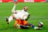 Lyon's Rayan Cherki, top, and Montpellier's Junior Sambia fight for the ball during the French League One soccer match between Lyon and Montpellier in Decines, near Lyon, central France, Saturday, Feb. 13, 2021. (AP Photo/Laurent Cipriani)