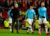 Manchester City's head coach Pep Guardiola, second from left, and team players leave the pitch after the English Premier League soccer match between Manchester United and Manchester City at Old Trafford in Manchester, England, Sunday, March 8, 2020. Manchester United won 2-0. (AP Photo/Dave Thompson)