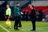 Basaksehir's manager Okan Buruk, right, argues with a referee during the Champions League group H soccer match between Paris Saint Germain and Istanbul Basaksehir at the Parc des Princes stadium in Paris, Tuesday Dec. 8 , 2020. (AP Photo/Francois Mori)