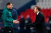Basaksehir's manager Okan Buruk, right, reacts next to Romanian 4th referee Sebastian Coltescu during the Champions League group H soccer match between Paris Saint Germain and Istanbul Basaksehir at the Parc des Princes stadium in Paris, Tuesday Dec. 8 , 2020. (AP Photo/Francois Mori)