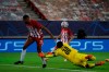 Marseille's goalkeeper Steve Mandanda saves the ball next to Olympiacos' Youssef El-Arabi during the Champions League group C soccer match between Olympiakos and Marseille at Georgios Karaiskakis stadium in Piraeus port, near Athens, Wednesday, Oct. 21, 2020. (AP Photo/Thanassis Stavrakis)