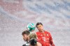 Bayern's Robert Lewandowski, right, jumps for the ball with Arminia's Manuel Prietl during a German Bundesliga soccer match between Bayern Munich and Arminia Bielefeld at the Allianz Arena in Munich, Germany, Monday, Feb. 15, 2021. (AP Photo/Andreas Schaad, Pool)
