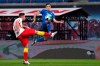 Hoffenheim's Christoph Baumgartner, right, challenges for the ball with Leipzig's Willi Orban during the German Bundesliga soccer match between RB Leipzig and TSG 1899 Hoffenheim in Leipzig, Germany, Friday, April 16, 2021. (AP Photo/Michael Sohn, Pool)